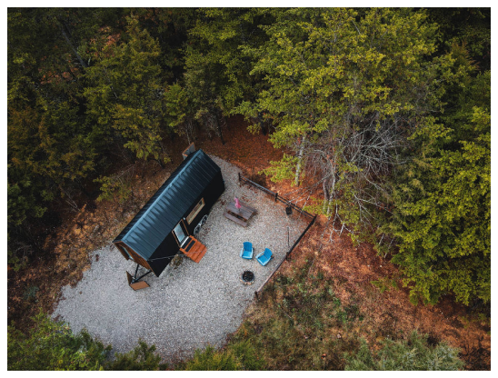 Photo of the Iris from overhead showing the cabin, the firepit and the outdoor searing area.
